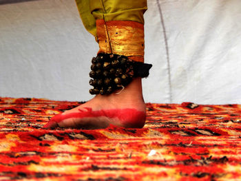 Low section of woman standing on red floor