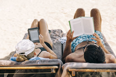 People relaxing on book at beach