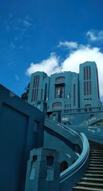 Low angle view of buildings against blue sky