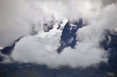 Snowcapped mountain covered by clouds