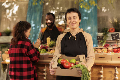 Portrait of young woman standing in market