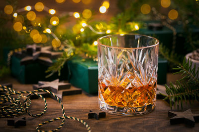 Glass of whiskey or bourbon with christmas decoration