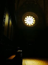 Low angle view of illuminated chandelier hanging in building