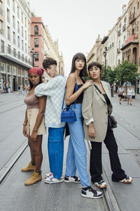 Young man with friends standing on street