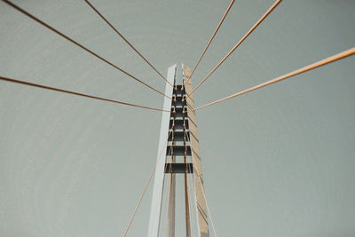 Low angle view of suspension bridge against sky