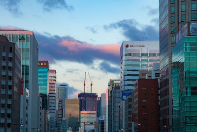 Low angle view of buildings in city against sky