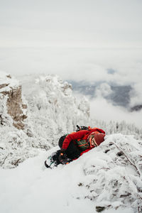 Rear view of woman skiing on snow covered landscape