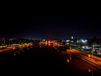 High angle view of illuminated city street and buildings at night