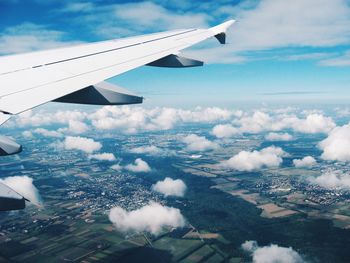 Aerial view of airplane wing over landscape