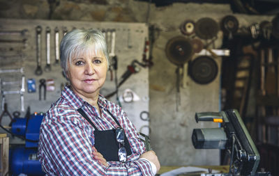 Portrait of woman standing in workshop