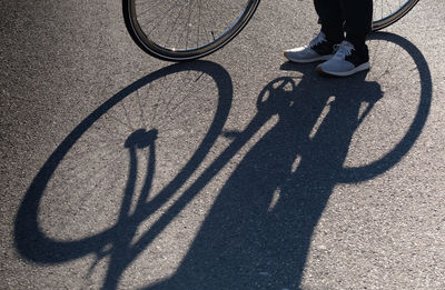 Low section of person riding bicycle on street