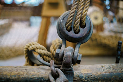 Close-up of rope tied on pulley at harbor