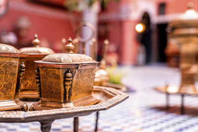 Ancient ornate brass pot with engraving on table