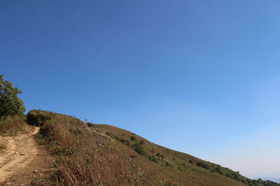 Scenic view of mountains against clear blue sky