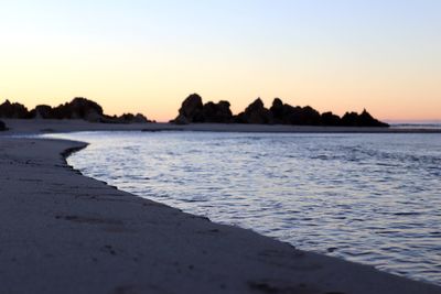 Scenic view of sea against clear sky during sunset