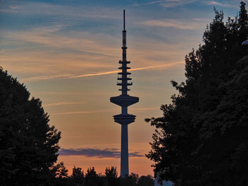 Low angle view of silhouette tower against sky at sunset