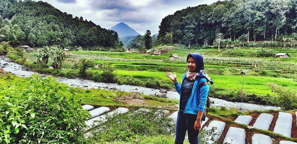 Full length of woman standing on field
