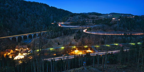 High angle view of illuminated bridge against sky at night