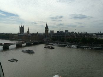 Boats in river with city in background