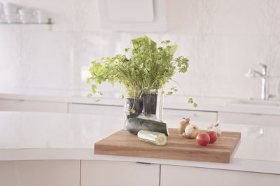 Vegetables and fruits on a clean table, white kitchen with scandinavian style