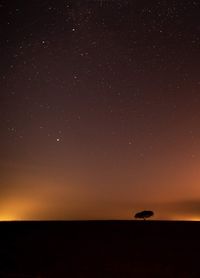 Scenic view of sea against star field at night