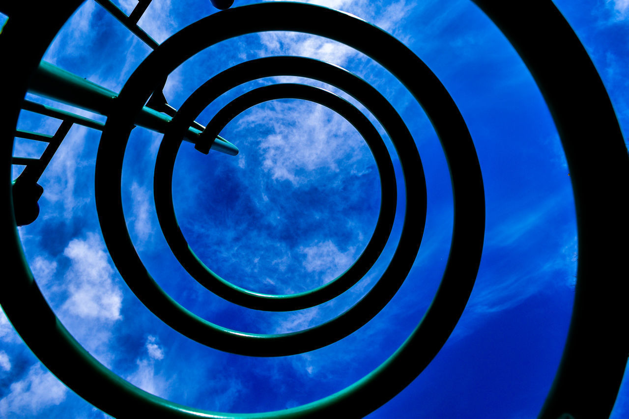 LOW ANGLE VIEW OF CLOUDY SKY SEEN THROUGH METALLIC STRUCTURE