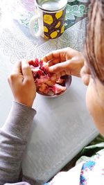 Midsection of woman holding ice cream on table