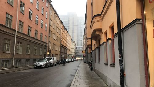 Cars on road amidst buildings in city