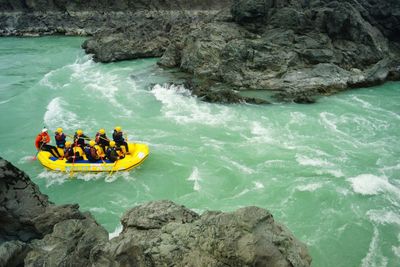 High angle view of people in raft on river