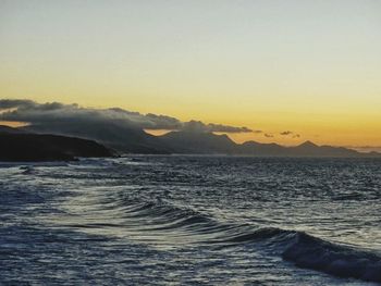 Scenic view of sea against clear sky during sunset