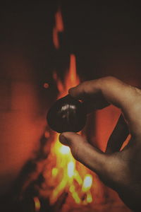 Close-up of hand holding hands at night