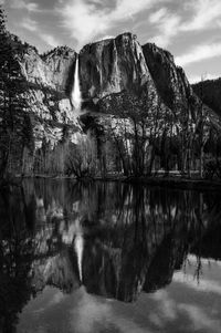 Black and white of bridal veil falls reflected in lake in yosemite valley national park california