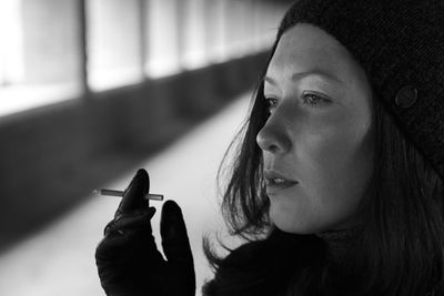 Close-up of young woman smoking cigarette