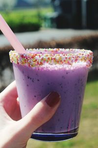 Close-up of hand holding drink