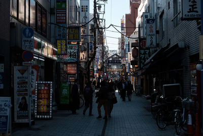 People walking on city street at night