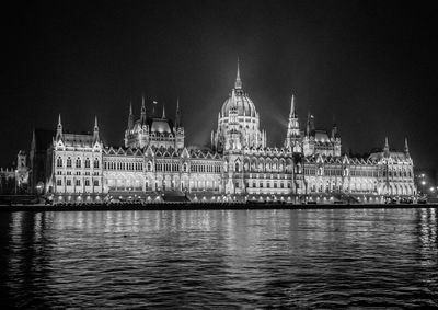 Illuminated city against sky at night