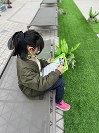 High angle view of boy playing with dog