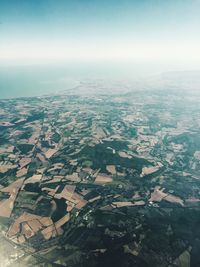 Aerial view of agricultural field against clear sky