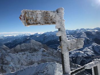 Built structure on snow covered mountain against sky