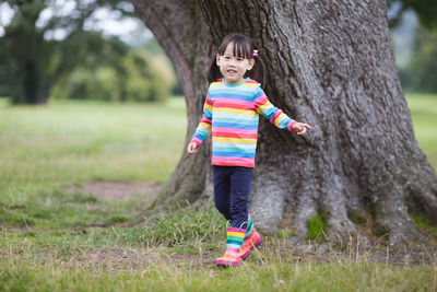 Young girl playing in the summer forest park