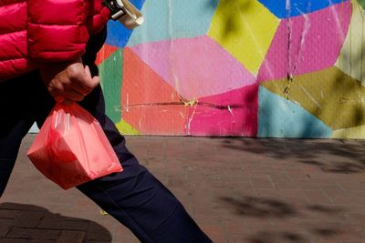 Full length of woman holding umbrella