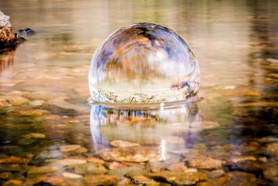 High angle view of crystal ball in lake