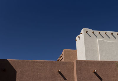 Low angle view of built structure against clear blue sky