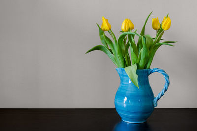Close-up of yellow tulip in vase on table