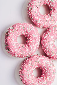 High angle view of pink donuts on table