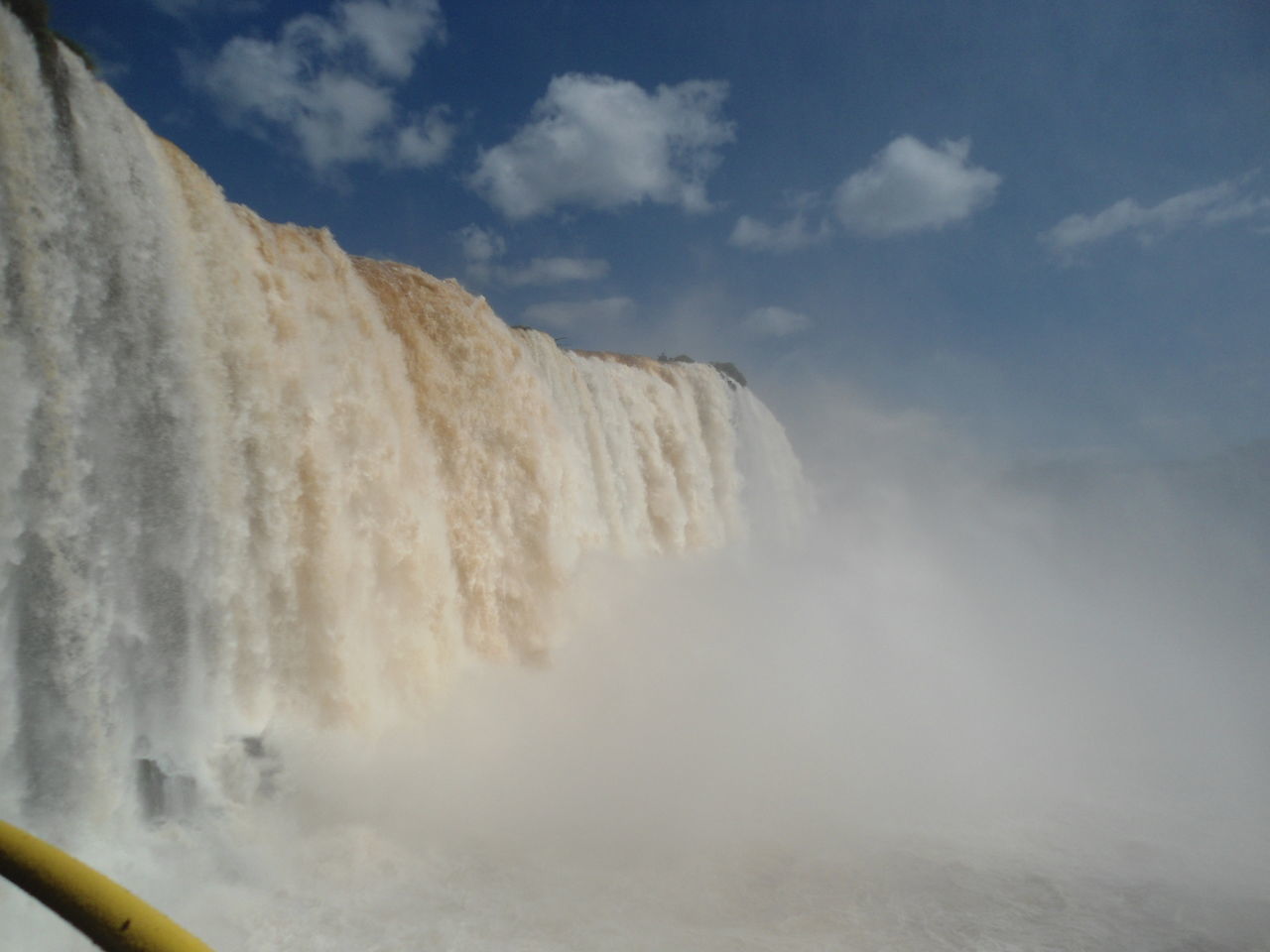 PANORAMIC SHOT OF WATERFALL BY PLANTS AGAINST SKY