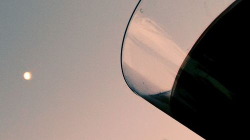 Low angle view of cropped car against sky