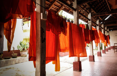 Orange robes drying in corridor