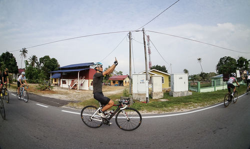 Man riding bicycle on road