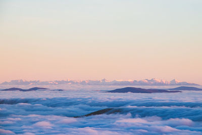 View of the high tatras in slovakia, which rise above the clouds and are covered with snow. 